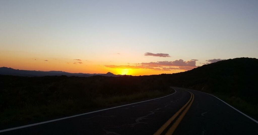 Sunsetting between the mountains with a road